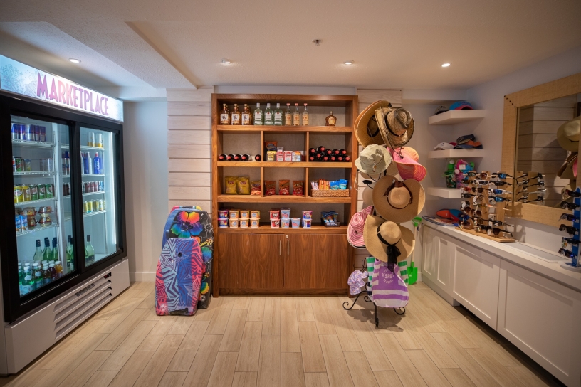 small shop that sells beverages, sun protection, and boogie boards