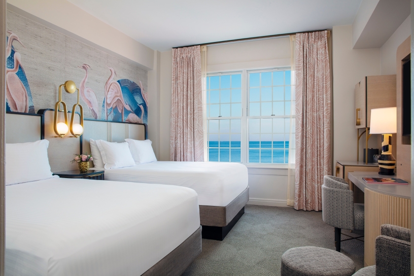 bedroom with two beds and view of the ocean